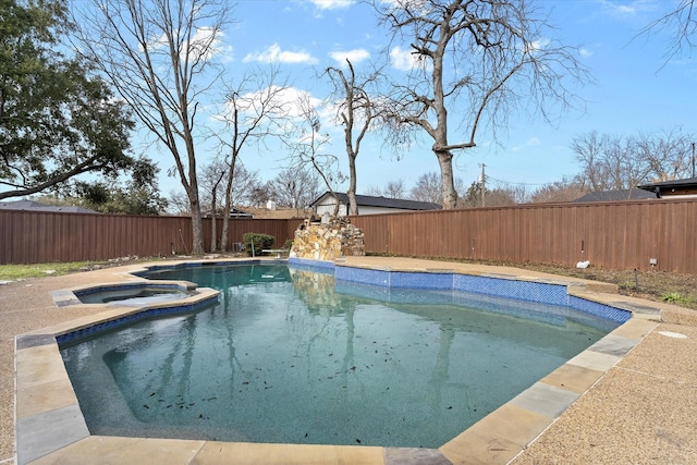 view of pool with a pool with connected hot tub and a fenced backyard