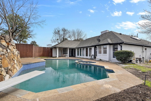 view of swimming pool with a diving board, an in ground hot tub, a patio, and a fenced in pool