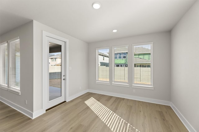 interior space featuring baseboards, recessed lighting, and light wood-style floors