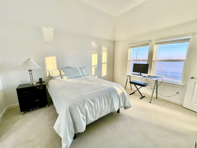 carpeted bedroom with lofted ceiling