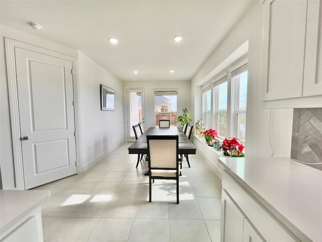 dining space featuring light tile patterned floors, baseboards, and recessed lighting