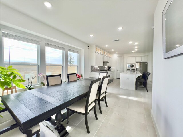 dining area featuring light tile patterned floors, recessed lighting, visible vents, and baseboards