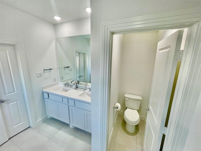 bathroom featuring vanity, tile patterned flooring, and toilet