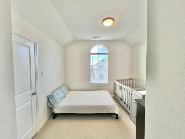 carpeted bedroom featuring lofted ceiling