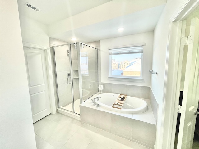 full bathroom with tile patterned flooring, visible vents, a shower stall, and a garden tub