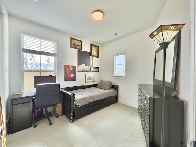 bedroom with light colored carpet and baseboards