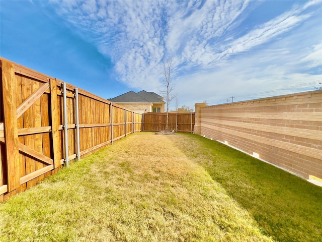 view of yard with a fenced backyard