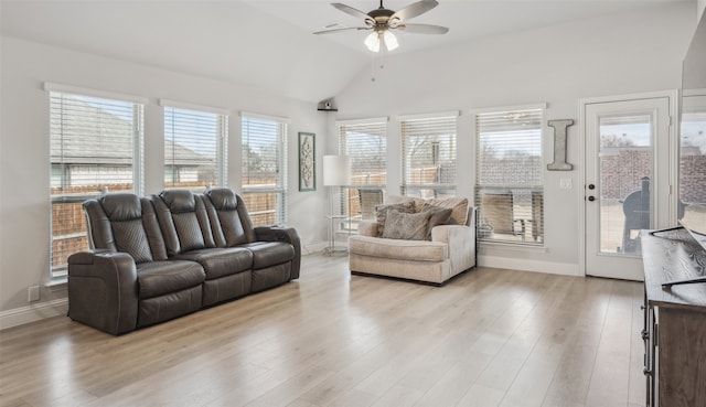 living room with baseboards, a ceiling fan, vaulted ceiling, and wood finished floors