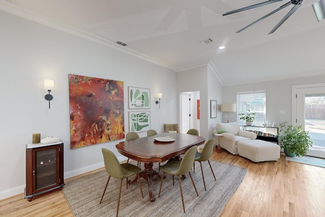 dining area featuring lofted ceiling, crown molding, light hardwood / wood-style flooring, and ceiling fan