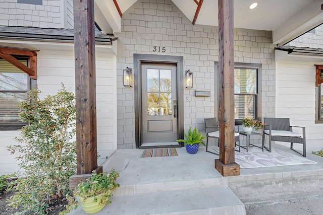 view of exterior entry with covered porch