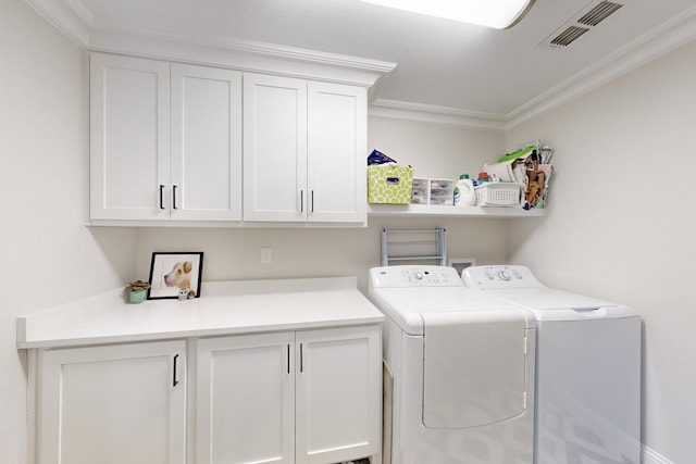 laundry room featuring cabinets, ornamental molding, and separate washer and dryer