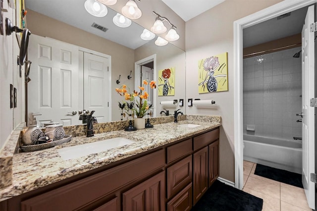 bathroom with vanity, tile patterned floors, and tiled shower / bath