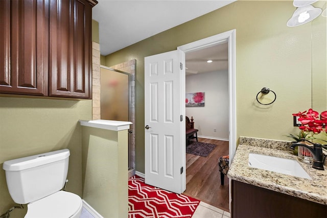 bathroom with vanity, tile patterned floors, toilet, and walk in shower