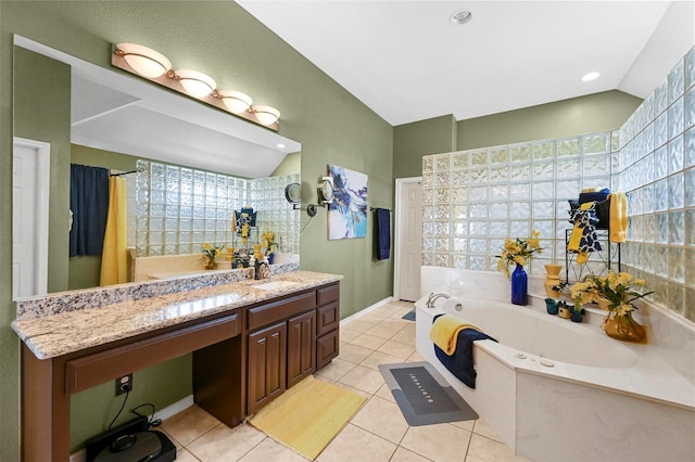 bathroom featuring vaulted ceiling, tile patterned floors, a bathtub, and vanity