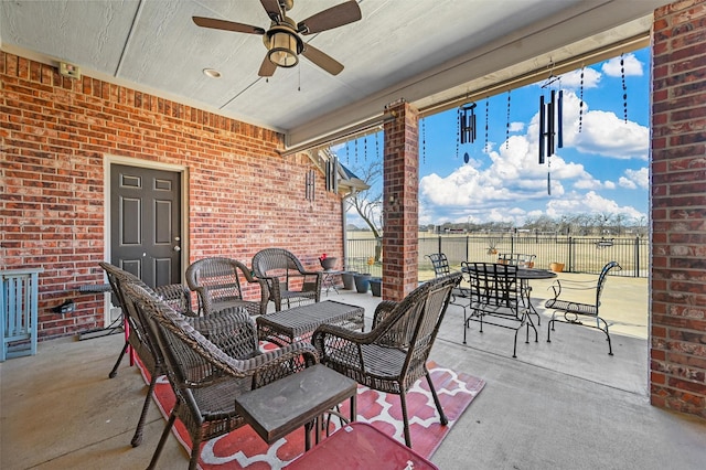 view of patio with an outdoor living space and ceiling fan