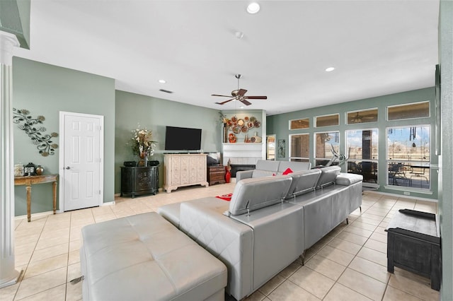 tiled living room featuring ceiling fan