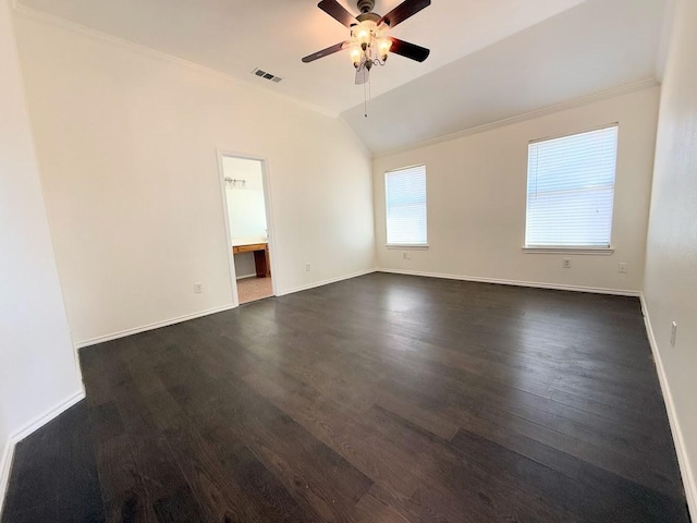 empty room with crown molding, dark wood-type flooring, vaulted ceiling, and ceiling fan