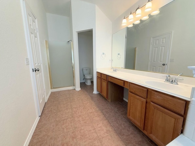 bathroom featuring vanity, a shower with shower door, and toilet