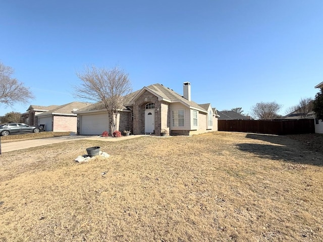 ranch-style house with a garage and a front yard