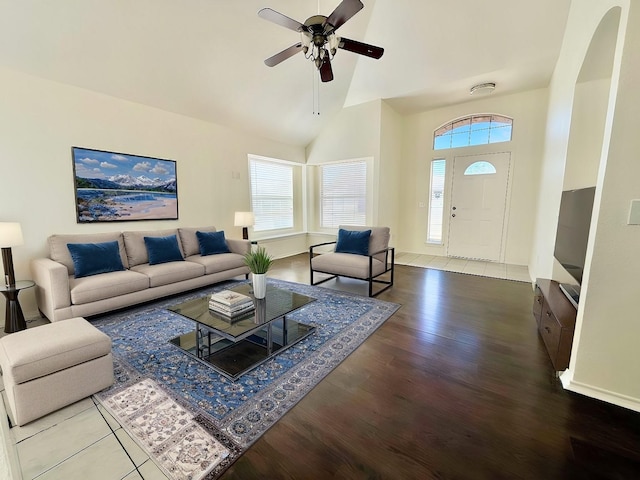 living room with hardwood / wood-style flooring, ceiling fan, and lofted ceiling