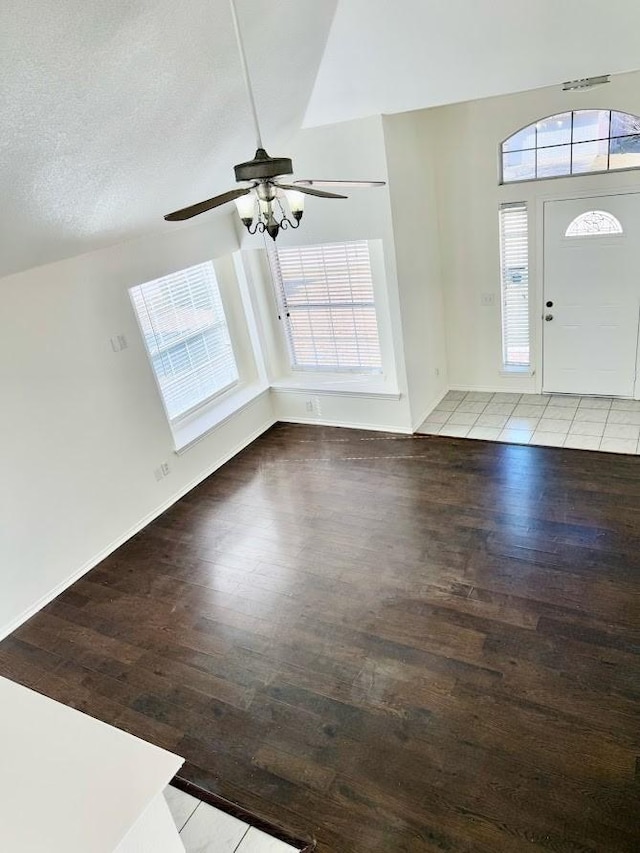 foyer entrance featuring ceiling fan, a textured ceiling, light hardwood / wood-style flooring, and a wealth of natural light