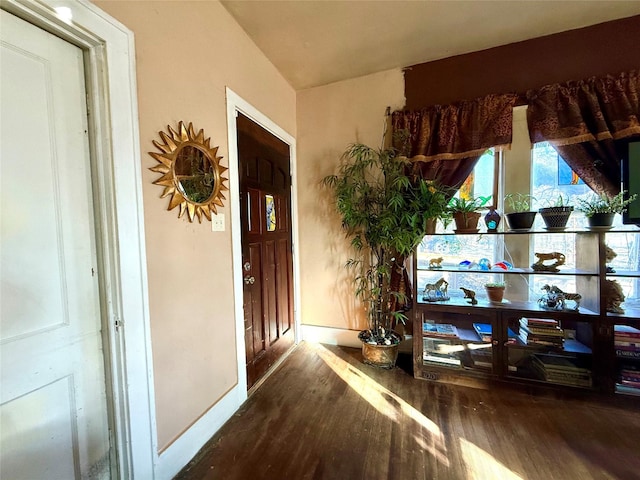 interior space with wood finished floors and baseboards