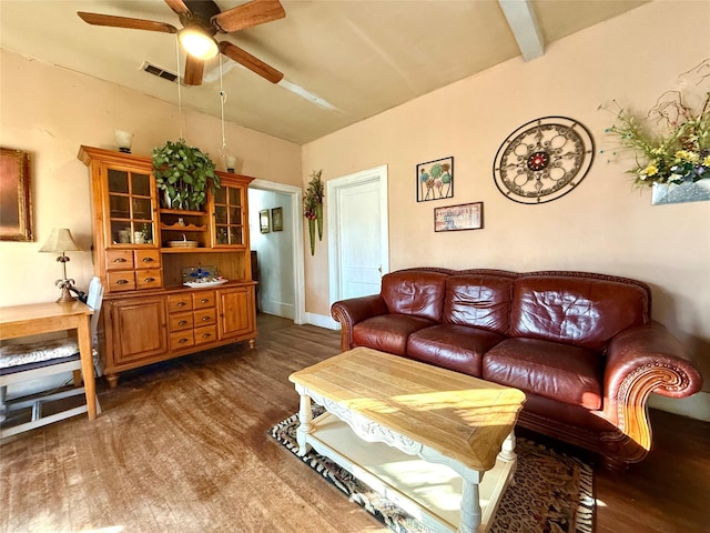 living room with a ceiling fan, visible vents, dark wood finished floors, and lofted ceiling with beams