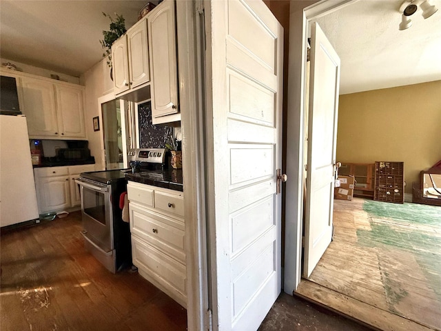 kitchen with tile countertops, white cabinetry, electric stove, freestanding refrigerator, and dark wood-style floors