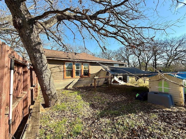 back of house with fence