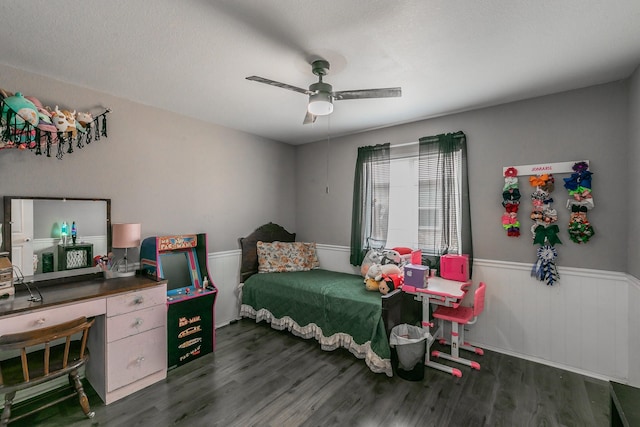 bedroom with dark hardwood / wood-style flooring, a textured ceiling, and ceiling fan