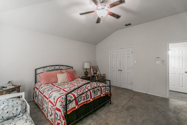 carpeted bedroom with ceiling fan, lofted ceiling, and a closet