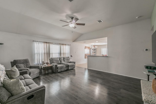 living room featuring vaulted ceiling, ceiling fan with notable chandelier, and dark hardwood / wood-style flooring