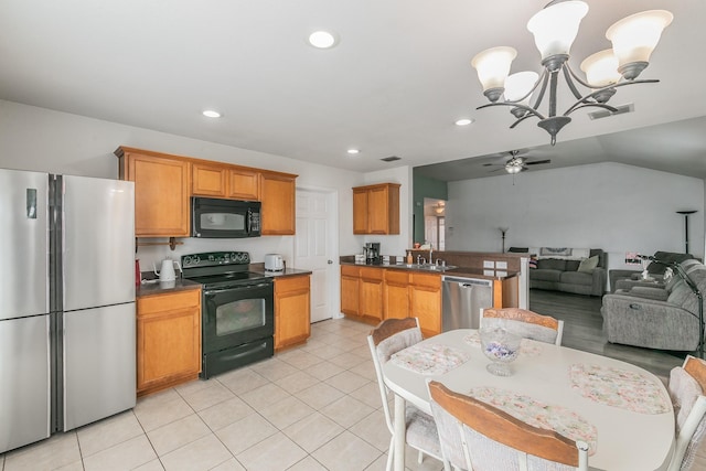 kitchen featuring vaulted ceiling, ceiling fan with notable chandelier, sink, light tile patterned floors, and black appliances