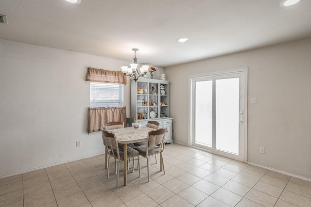 dining room with light tile patterned flooring and an inviting chandelier