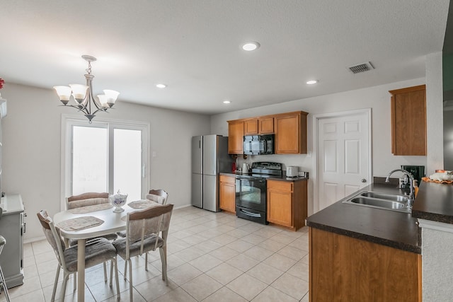 kitchen featuring sink, a chandelier, hanging light fixtures, light tile patterned floors, and black appliances