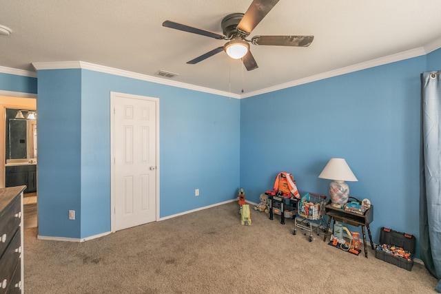 recreation room featuring crown molding, ceiling fan, and carpet