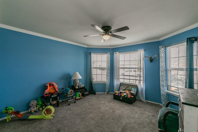 rec room with crown molding, carpet flooring, and ceiling fan