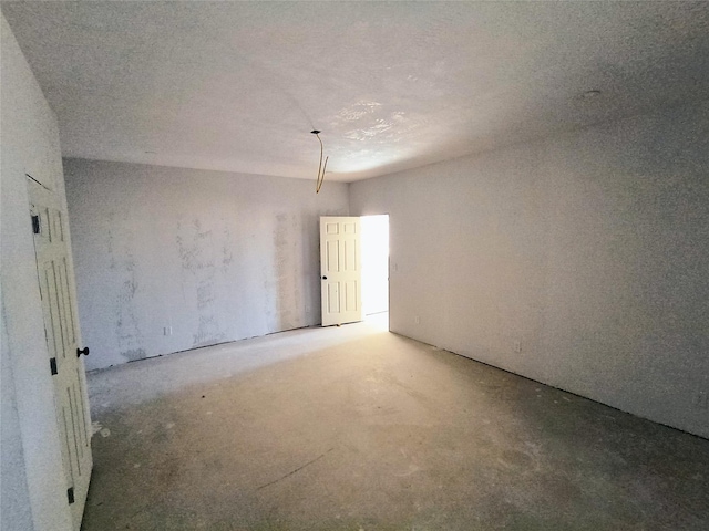 unfurnished room with concrete floors