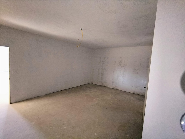 unfurnished room featuring concrete floors