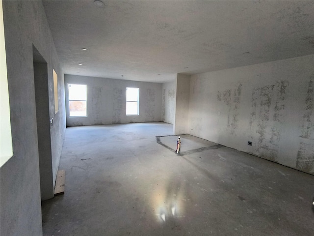 unfurnished room featuring concrete floors