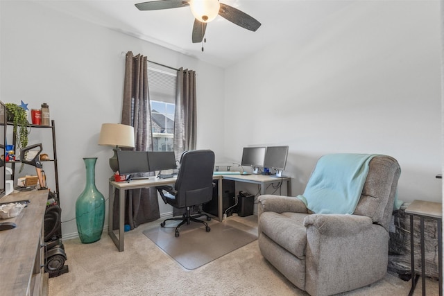 home office featuring light carpet and ceiling fan