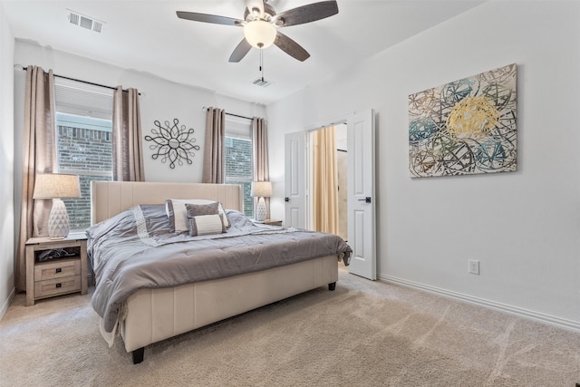 bedroom with ceiling fan and light carpet