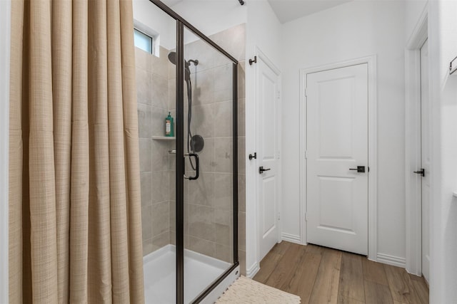 bathroom featuring wood-type flooring and walk in shower