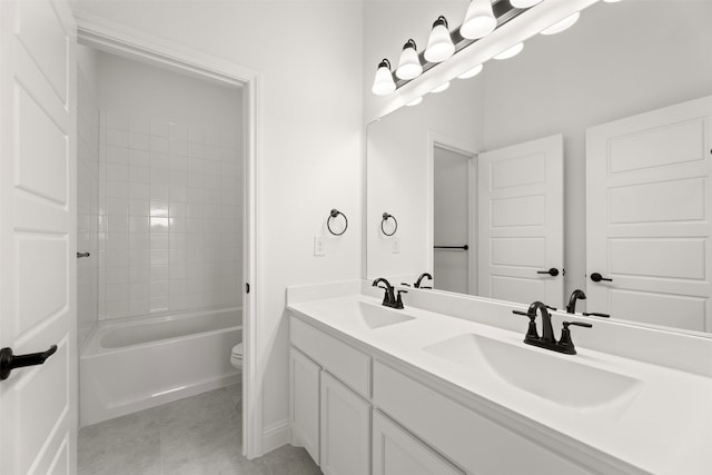 full bathroom featuring tiled shower / bath combo, vanity, tile patterned floors, and toilet