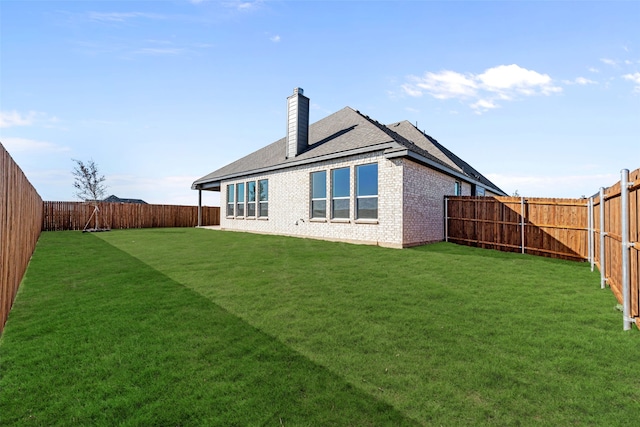 rear view of property featuring a yard