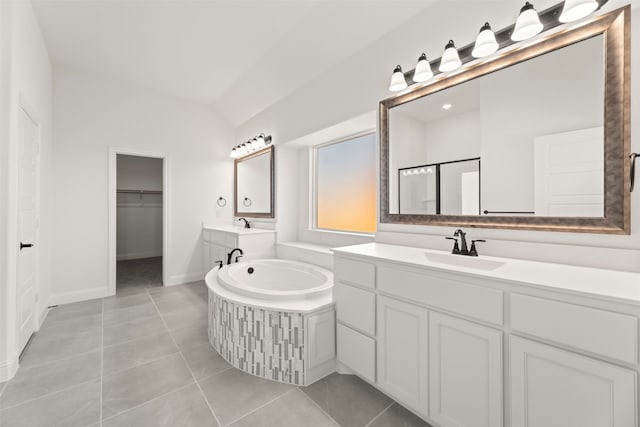 bathroom with lofted ceiling, vanity, tile patterned floors, and separate shower and tub