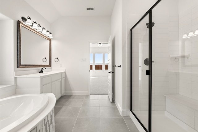 bathroom featuring a shower with door, ceiling fan, tile patterned flooring, vanity, and vaulted ceiling