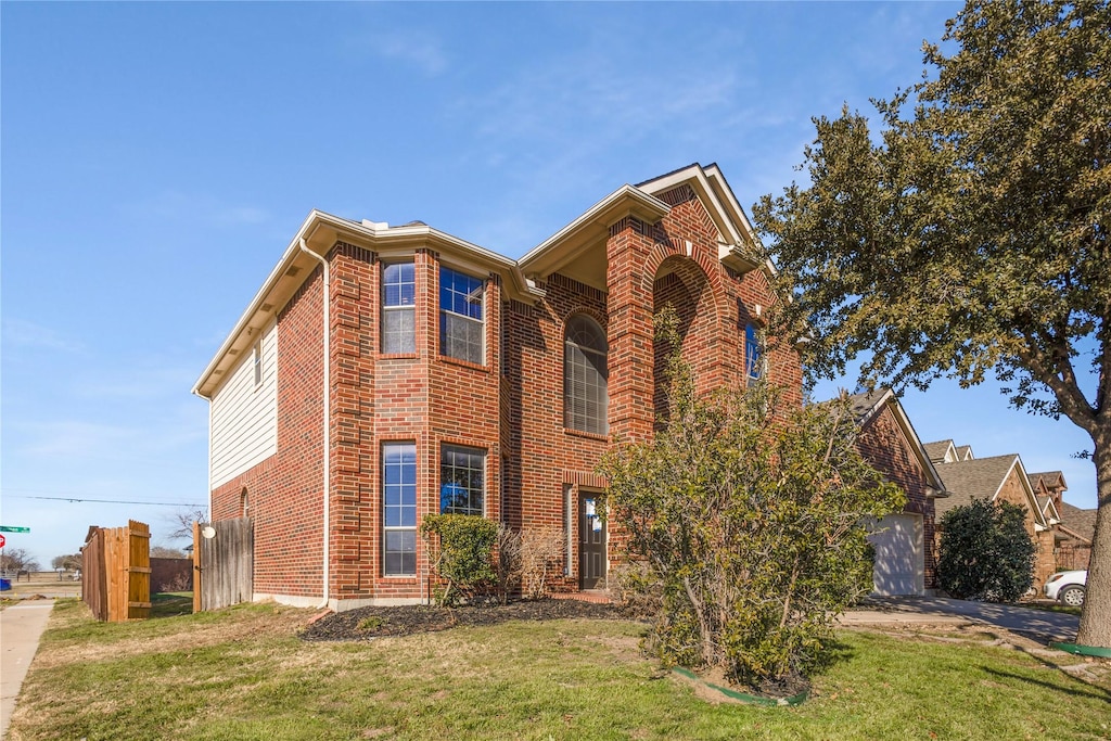 view of front of property with a garage and a front lawn