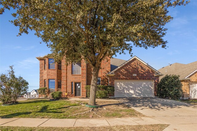 view of front of house with a garage and a front yard