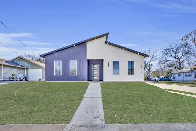 view of front facade featuring a garage and a front lawn